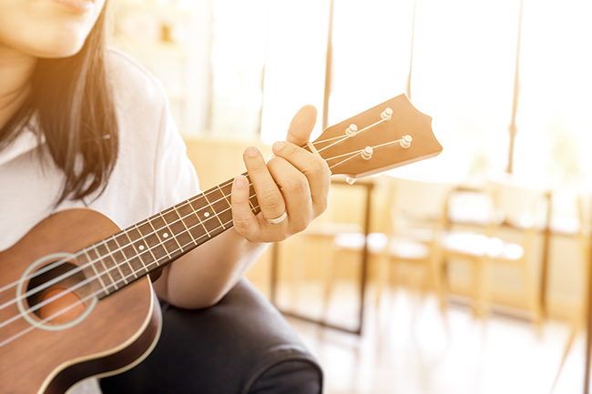 woman handicraft playing ukulele